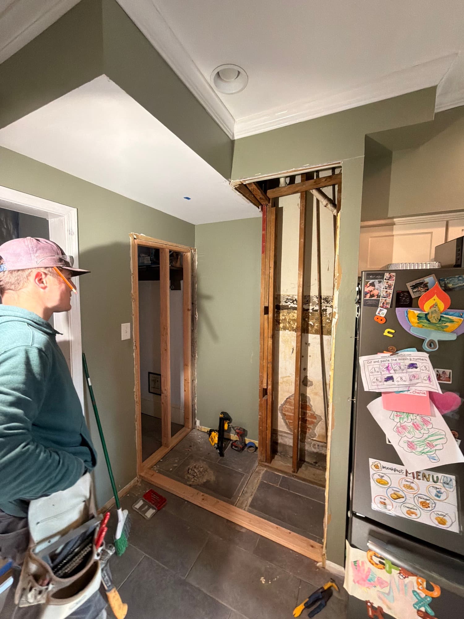 Interior wall opened up to framing during a kitchen renovation